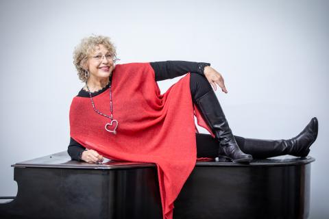 Margaret Chalker poses on piano