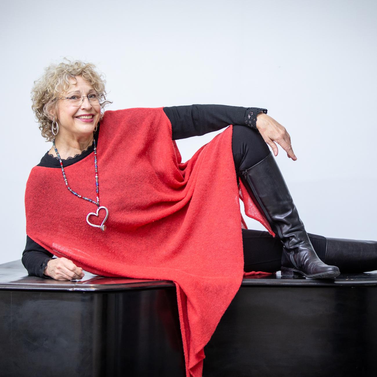 Margaret Chalker poses on piano